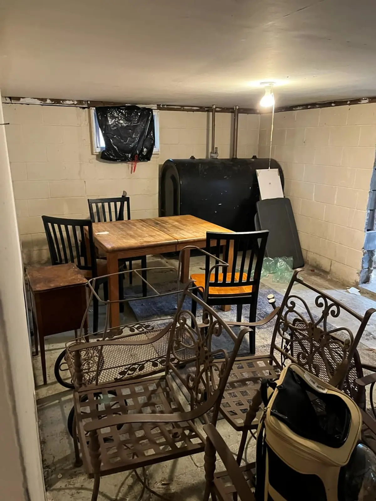 Selling a house with a reverse mortgage in Riverhead: back deck crowded with bins and a rusty grill