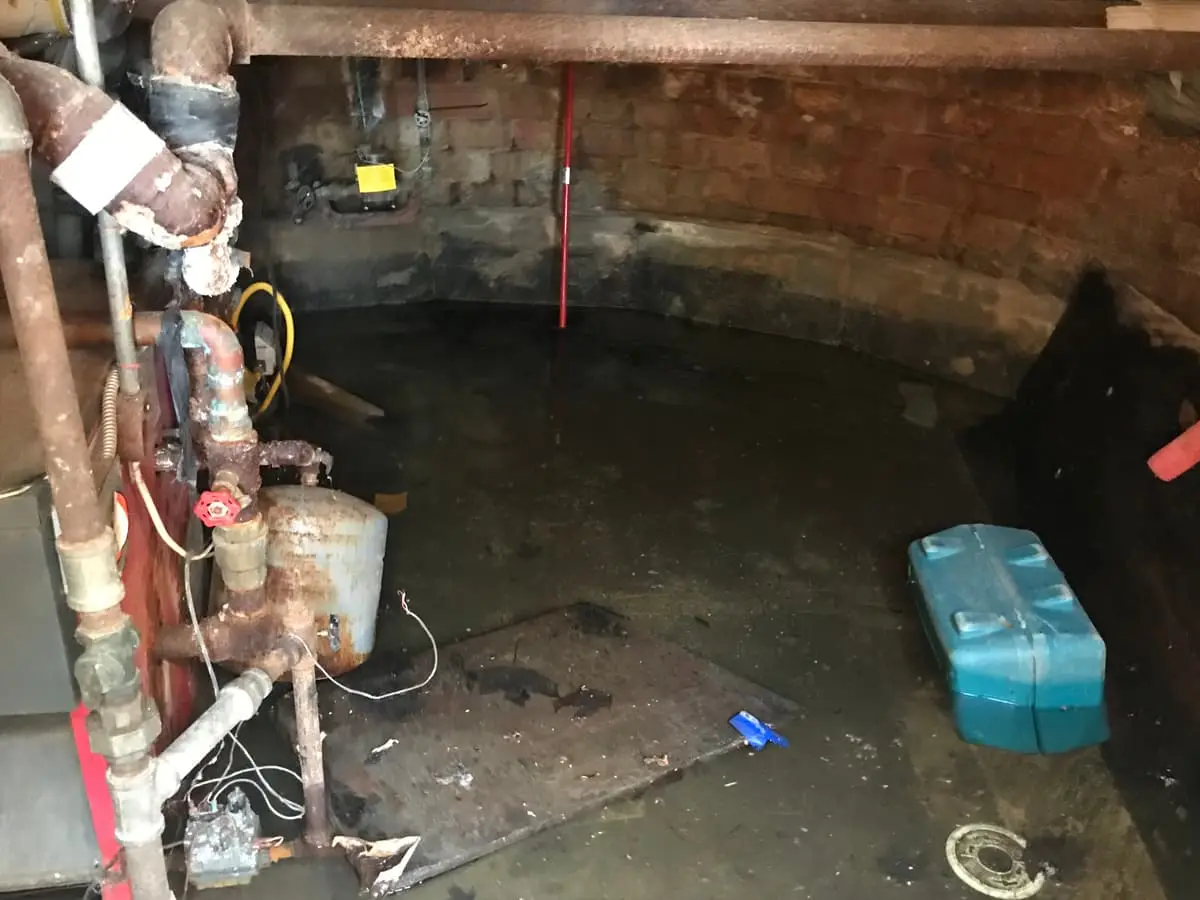 Selling a house in a flood zone in Riverhead: basement floor under standing water by the boiler