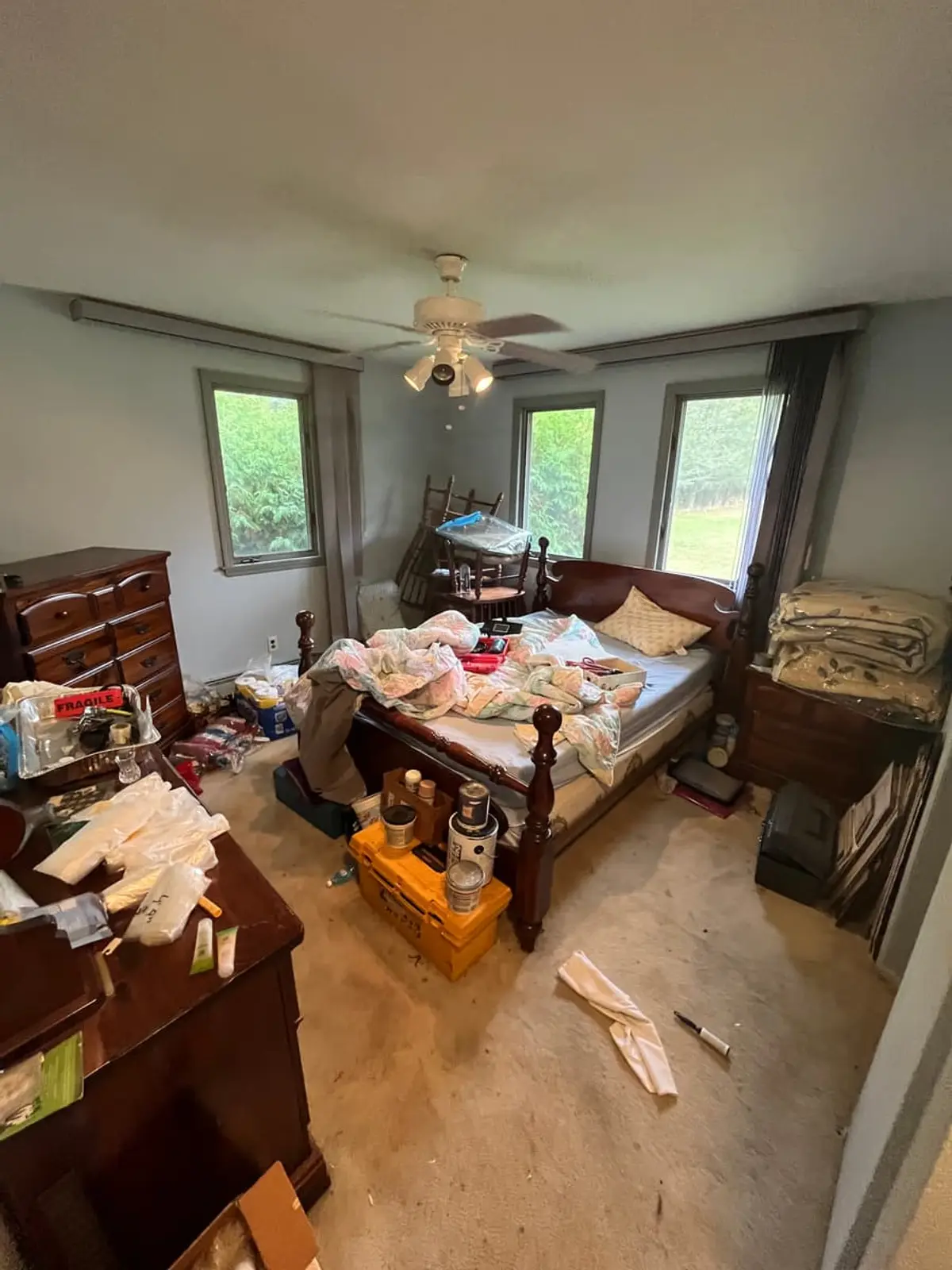 Selling a house during a divorce in Riverhead: bedroom with an unmade bed and scattered belongings