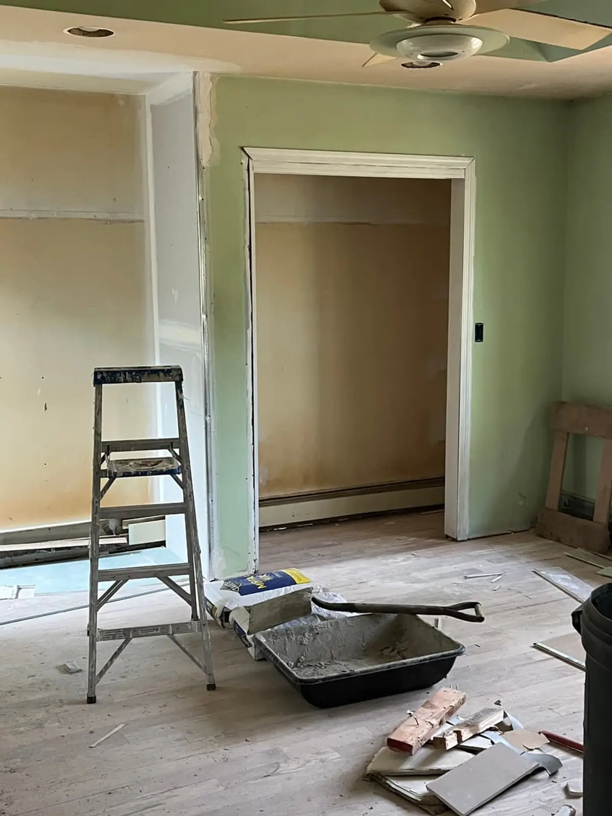 Selling a house with foundation problems in Riverhead: bedroom with fresh flooring, a ladder and mortar tub