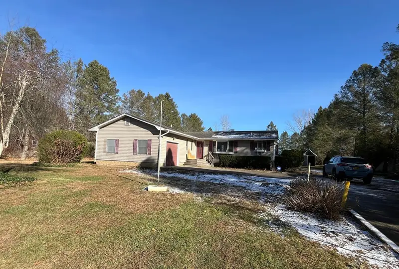 Gray ranch with maroon shutters and a dusting of snow, Riverhead, NY