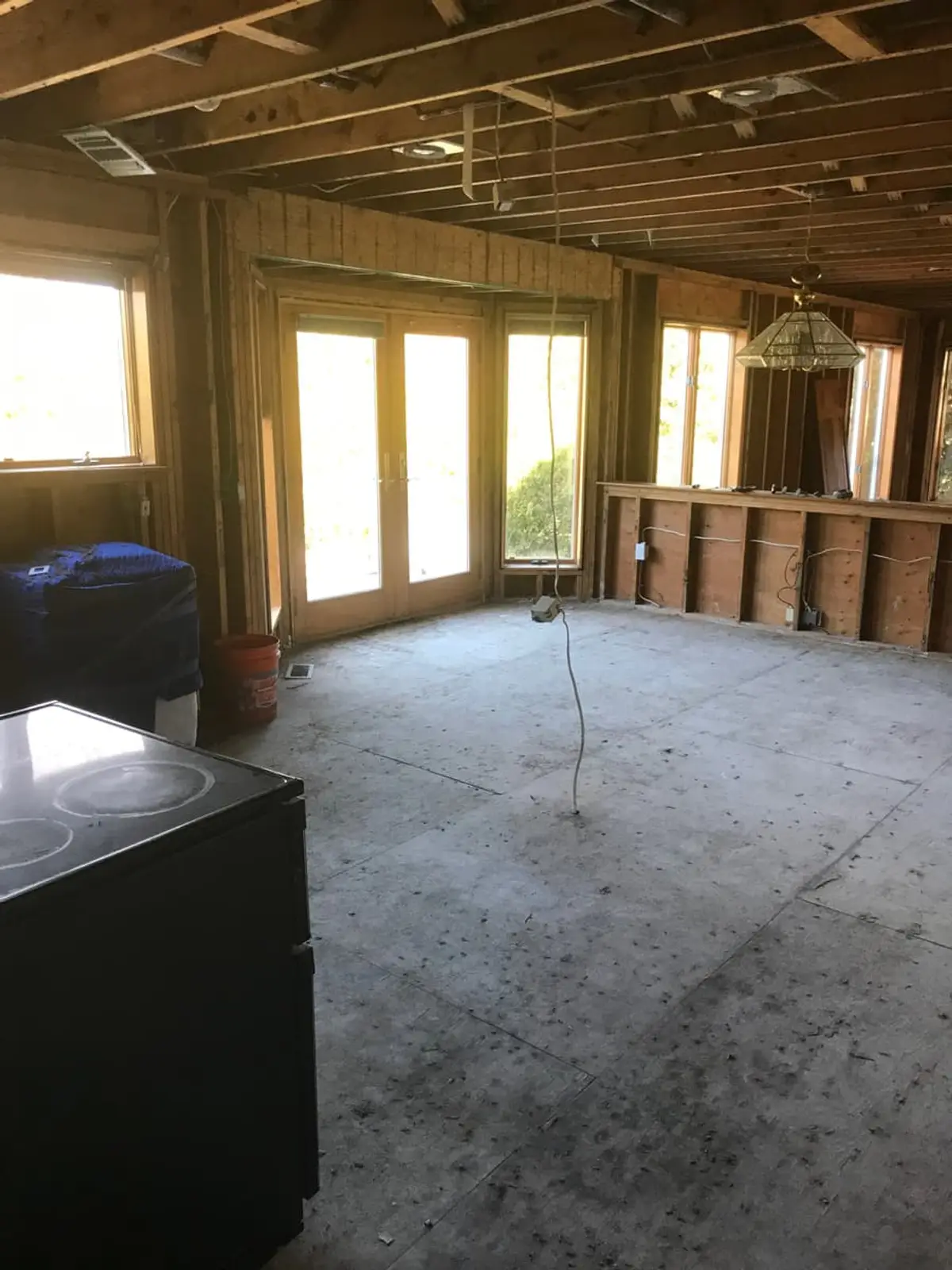 Selling a house with unpermitted work in Riverhead: gutted kitchen with open joists and French doors
