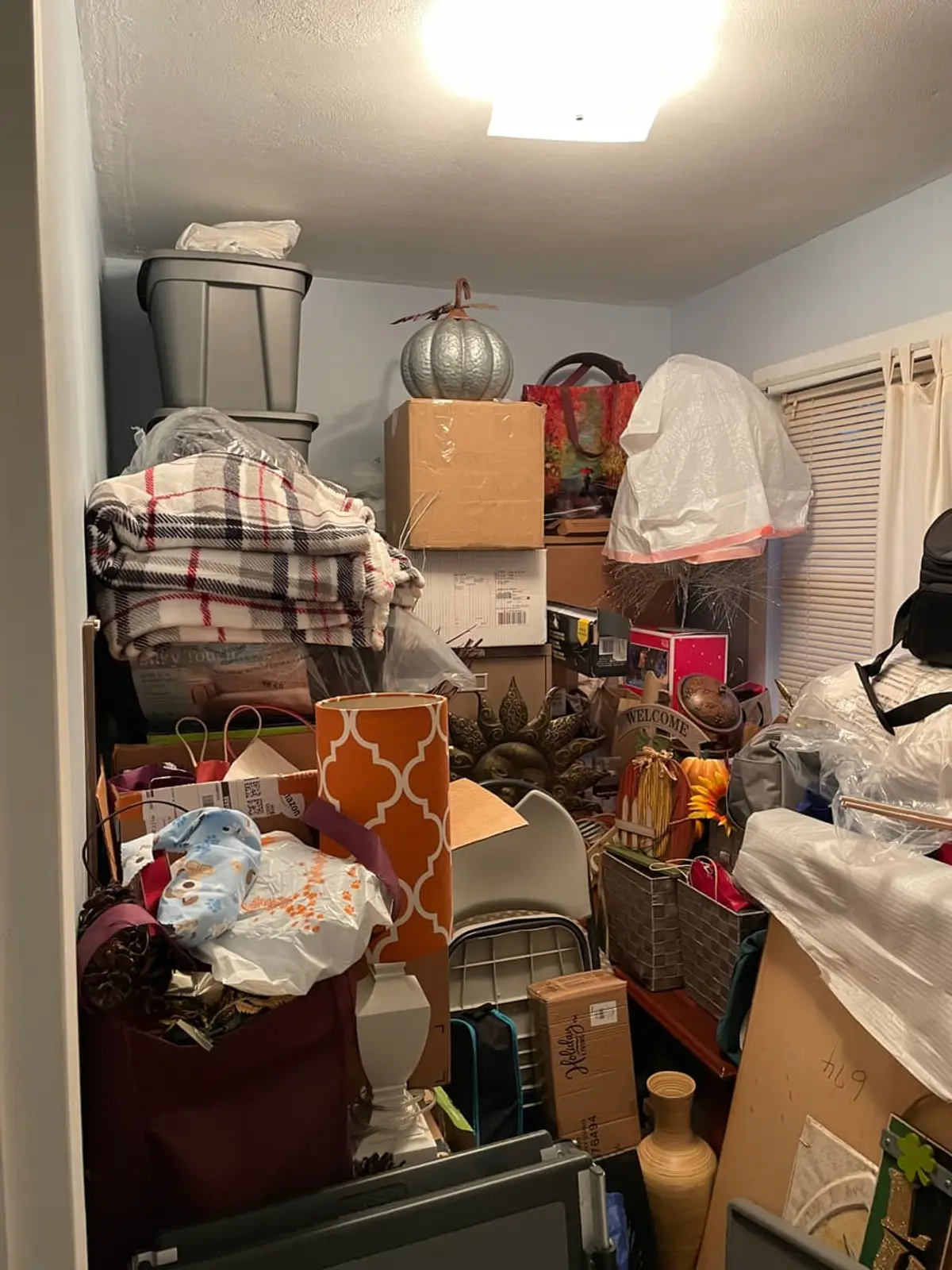 Selling a hoarder house in Riverhead: small room stacked to the ceiling with boxes